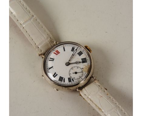 A silver cased trench wristwatch, the circular white enamel dial, with subsidiary seconds dial, stamped 925 to inner case
