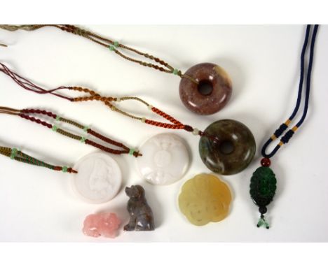 Five Oriental jade style pendants, together with a rose quartz figure of a pig and a hardstone figure of a seated dog (8)