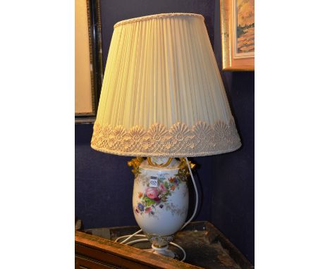 An early 20th century Naples porcelain table lamp, decorated with hand painted  floral panels, with shade, 70cm high