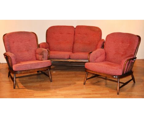 An Ercol lounge settee with pair of matching armchairs, upholstered in pale red fabric, settee 76cm high x 140cm wide