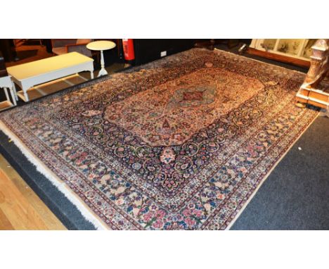 A large Persian Yazd carpet, decorated with large central medallion on cream ground, 451cm long x 298cm wide