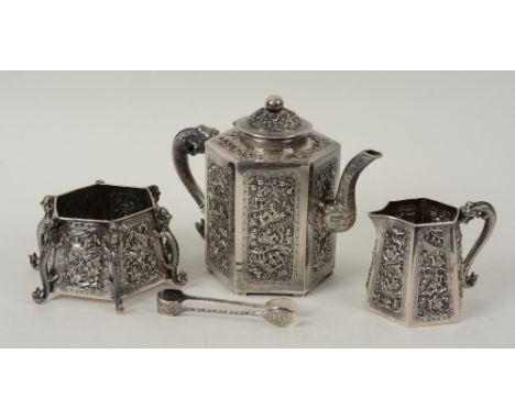 An early 20th century Chinese silver tea service, decorated with figures to each panel, with mythical beast handles, comprisi