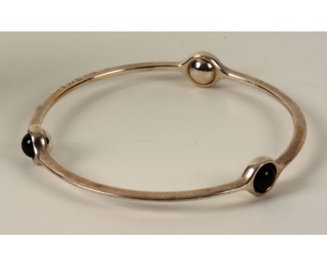 A Georg Jenson silver bangle, with three black enamel cabochons, dated 2012, in original fitted box, 7.5cm diameter (matches 