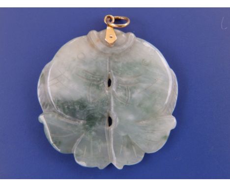 A circular jade pendant fashioned as a pair of carp, 1.5” diameter.