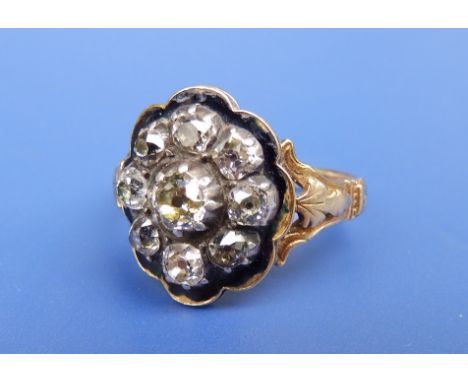 A George IV memorial diamond cluster ring in 18ct gold , the nine old cut stones set in silver onto a black enamelled  mount,