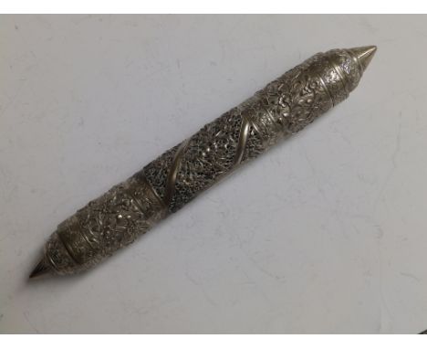 A Chinese white metal scroll holder, having pointed ends, decorated overall with flower scroll and with openwork panels to ce