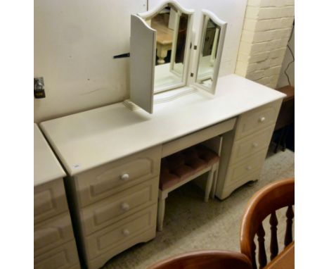 A modern white painted six drawer dressing table, surmounted by a triptych mirror, raised on bracket feet  51''h  58''w; and 