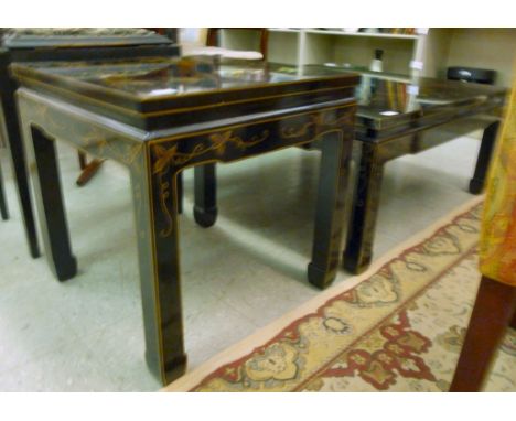 A modern Chinese black lacquered and floral painted coffee table, raised on square legs  16''h  36''w; and a matching lamp ta