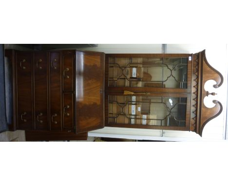 A modern George III inspired mahogany finished bureau bookcase, having a swan neck pediment, over twin glazed, panelled doors