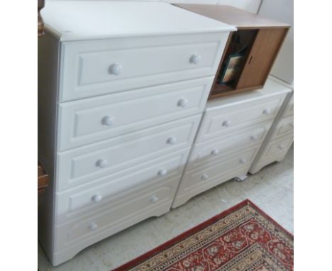 A modern white painted five drawer tallboy, raised on bracket feet  45''h  32''w; and a similar three drawer dressing chest  