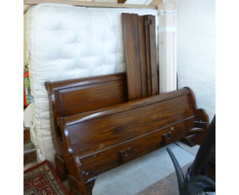 A modern French design mahogany sleigh bed, having a panelled scrolled head and foot board, raised on a bracket feet  76''w a