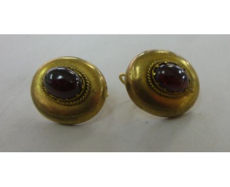 A pair of vintage yellow metal oval tablet earrings, set with garnets       11