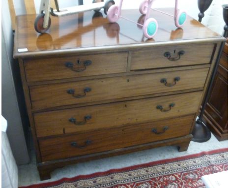 A mid 19thC mahogany dressing chest, the two short/three graduated long drawers with brass bail handles, raised on a bracket 