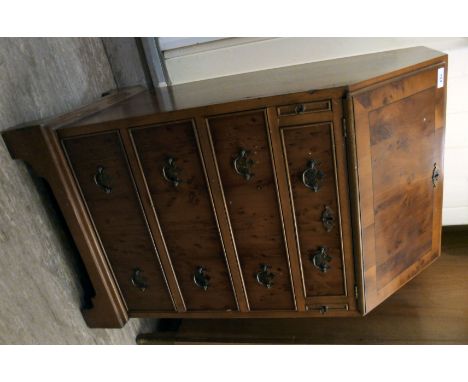 A 1960s lady's yew wood finished bureau, the fall front enclosing a fitted interior, over twin lopers and four drawers with b