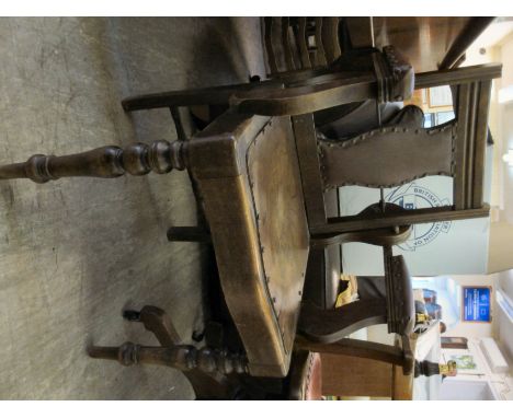 A late Victorian mahogany framed barber's chair, having angle adjustment on the studded rexine upholstered splat back, the op