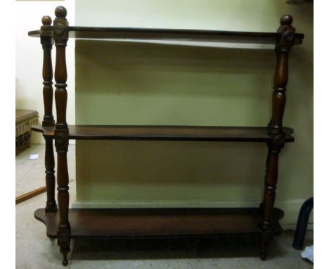 A Victorian mahogany hanging shelf, having three tiers, united by turned supports  22''h  28''w       SR