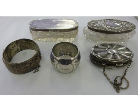 Silver items: to include a hinged bangle; and an oval purse with a fitted interior  mixed marks         11