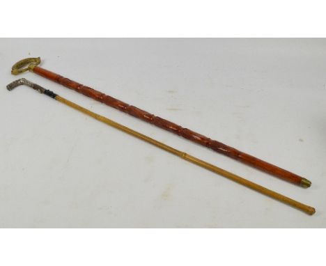 A bamboo stick with hallmarked silver spirally decorated handle and an incised example with brass ring handle (2).