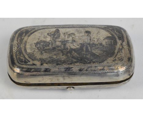 A late 19th century Russian silver and niello decorated snuff box, depicting a ploughing scene to the hinged lid enclosing gi