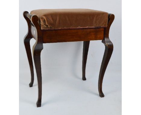 An early 20th century walnut piano stool with hinged seat and cabriole legs.