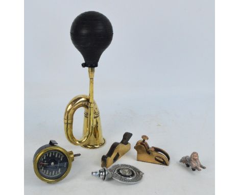 A group of automobilia related items, a brass car horn, a Smiths rev counter, a RACA Halifax Automobile Club car mascot with 