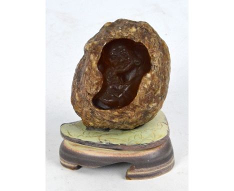 A Chinese carved boulder depicting an elderly man with child, on hardstone base, height 13.5cm.