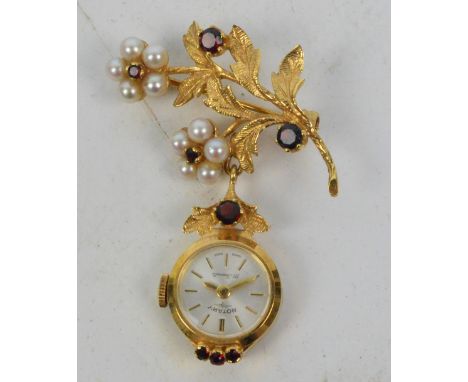ROTARY; a 9ct yellow gold cased lady's watch with twenty-one jewels decorated with garnets and suspended from a 9ct yellow go