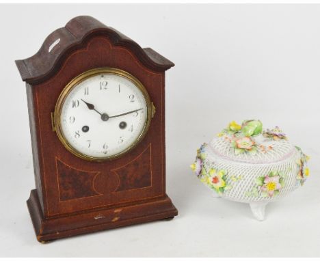 An Edwardian mahogany and inlaid eight day mantel clock with shaped domed pediment, the circular dial set with Arabic numeral