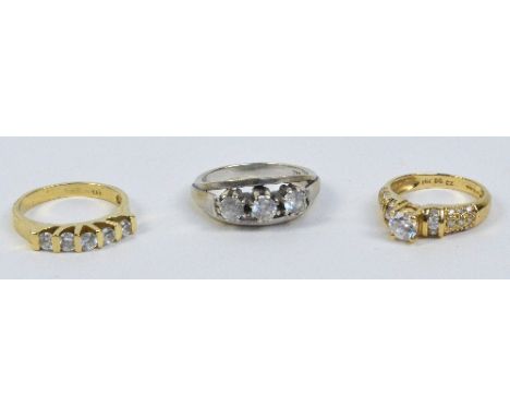 A 14ct yellow gold ring with five bar set clear stones, size O, a 14ct yellow gold dress ring with one raised clear stone fla