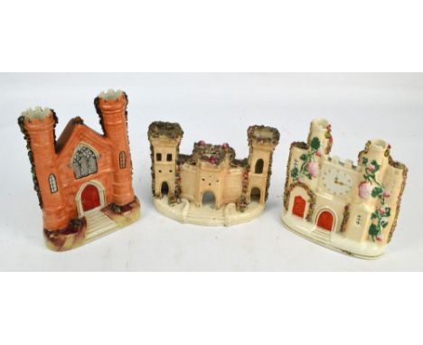 Three Victorian Staffordshire models of castles with combware ornaments, one with clock face, height 19.5cm. CONDITION REPORT