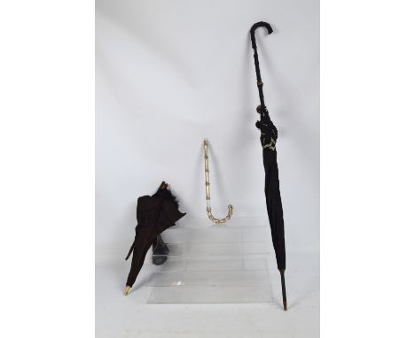 A late 19th century silk parasol with tassel decoration and wooden handle, with a bone finial (af), length 75cm, a white meta