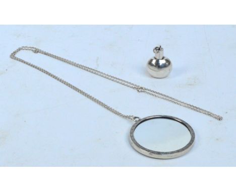 A sterling silver backed circular mirror pendant with engine turned decoration, Henry Matthews, diameter 5cm, on long open li