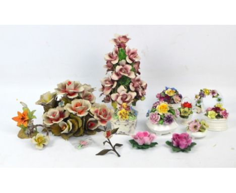 A collection of floral ceramics including table centrepieces, trinket boxes, candle holders, and ornaments, including items b