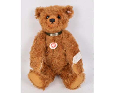 A boxed British Collectors' 2009 Steiff teddy bear no.663246, with numbered white and red tag to ear, with reddish brown curl