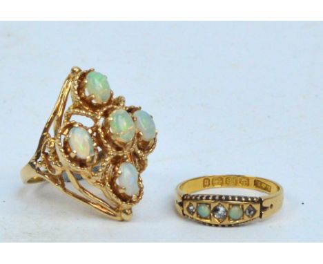 An 18ct yellow gold dress ring set with two small opals and three small diamonds, size N and a large dress ring set with five