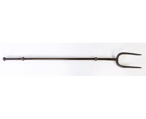                         A 19th century wrought iron log or fire fork, with knopped decoration to stem and two arched tines, 9