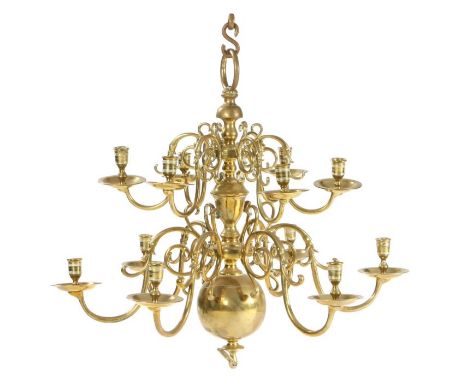                         An impressive brass chandelier,with two graduated tiers of twelve scrolling candle branches, terminat