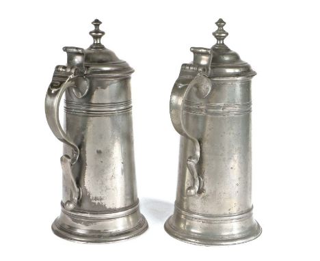                         A near pair of GEORGE III PEWTER SPIRE FLAGONS, CIRCA 1760                         By William Charsle