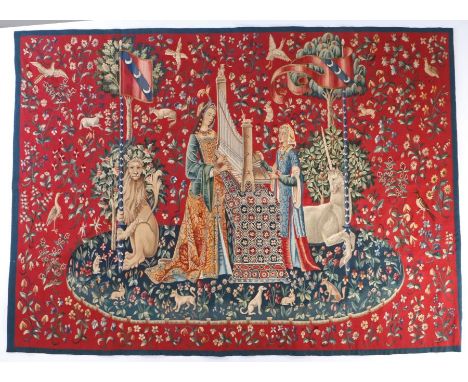 
    
        
            A Medieval style 'Unicorn' tapestry, centred by two ladies, one playing a harp, flanked by a unico