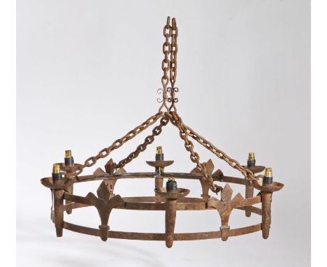                         A Gothic-Revival wrought-iron chandelier, of crown form, hung on four chains, the six candle sconces 