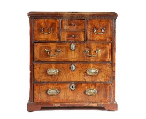                         A small George II pine and walnut-veneered chest of drawers, East Anglian, the rectangular top above 