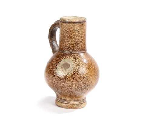                         A 17th century stoneware jug, Cologne/Frechen, the spout above a loop hand and bulbous body with ring