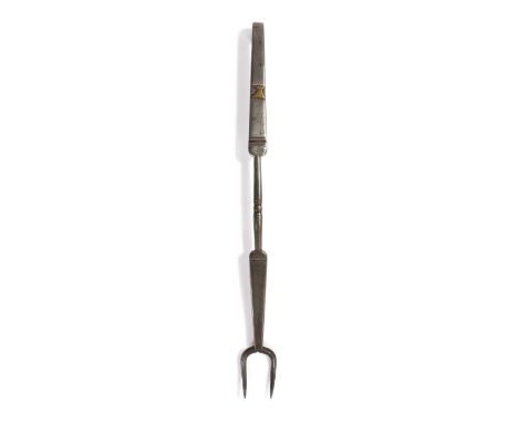An iron and brass-inlaid meat fork, circa 1800, with two tines, the stem flattening and narrowing to the centre with a small 