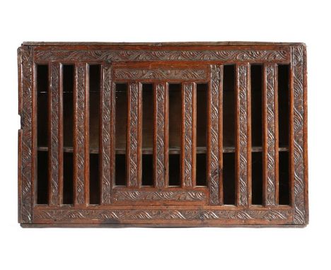                         A Charles II carved oak mural ventilated livery cupboard, West Country, Devon, the front of lathe con