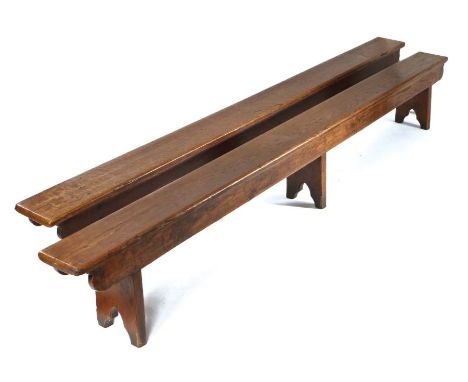                         Two 19th century oak boarded benches, the long rectangular tops above shaped-end aprons, on boarded s