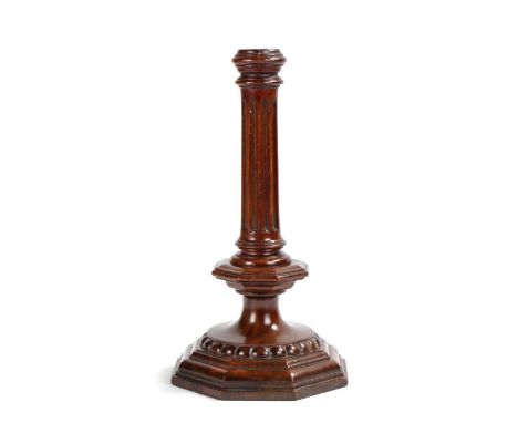                         A treen candlestick of late 17th century design, with fluted pillar, octagonal collar and beaded base