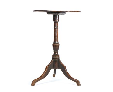                         A George III oak wine table, having a good one-piece circular top, on a vase-turned pillar and three 