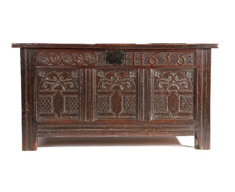                         A Charles I oak coffer, dated 1636, with triple-panelled lid, the front of three panels, each carved 