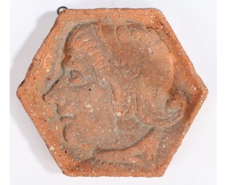                         A 16th century hexagonal terracotta tile, French, Billom (Auvergne), designed with a Romayne -type bu