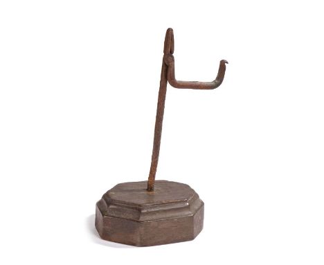                         A 19th century wrought iron and 'fruitwood' table rush light holder, English, the iron nips with angu